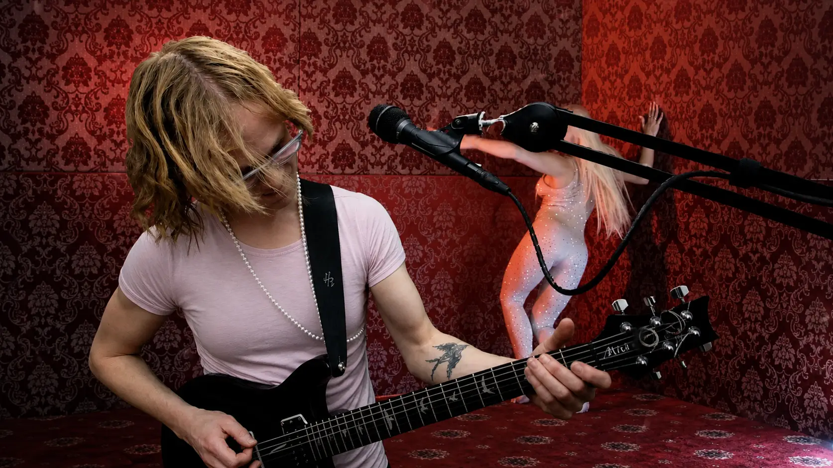 LaRedoux live on stage, performing guitar and vocals on a Halloween Stream on Twitch and YouTube